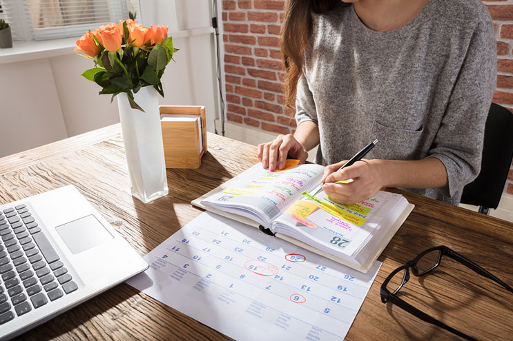 Woman with calendar at desk